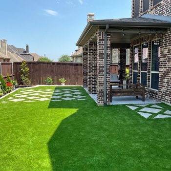 turf design ideas for a backyard with a real garden along the edges and pavers to the covered patio.