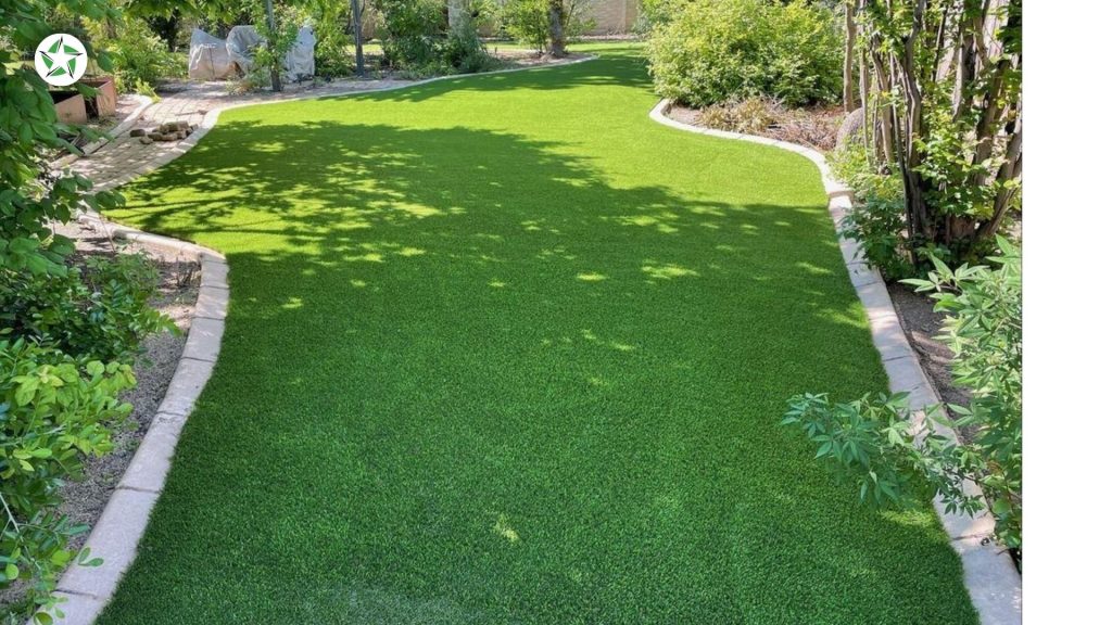Narrow turf lawn edged in stone between garden beds, graded so water keeps moving the way it did before year one with artificial turf, Year One With Artificial Turf: What to Expect, Lone Star Turf Texas