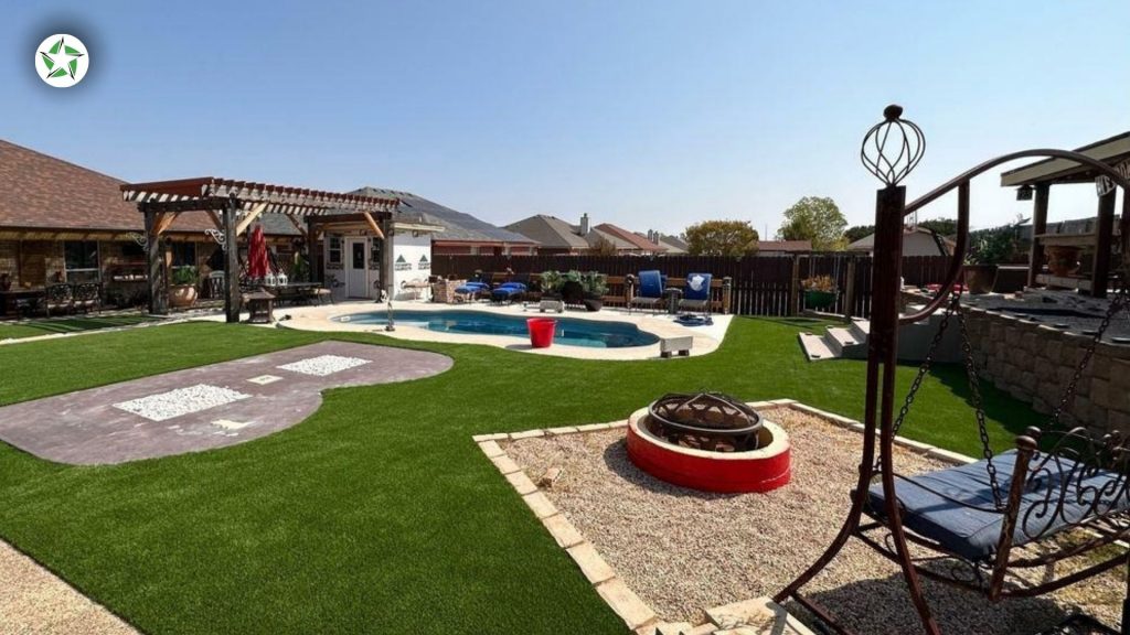 Turf lawn wrapping a backyard pool and fire pit under a cloudless Texas sky during the first summer of year one with artificial turf, Year One With Artificial Turf: What to Expect, Lone Star Turf Texas
