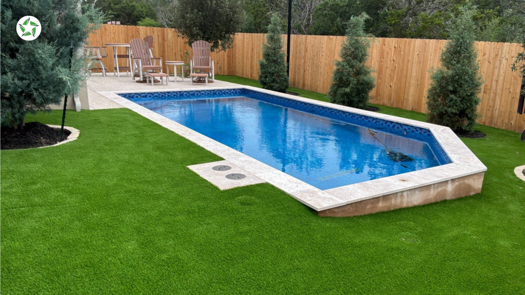 Rectangular pool with paver decking and turf around the pool, a Lone Star Turf Texas installation featured in Turf Around the Pool: Pavers vs. Concrete vs. Turf.