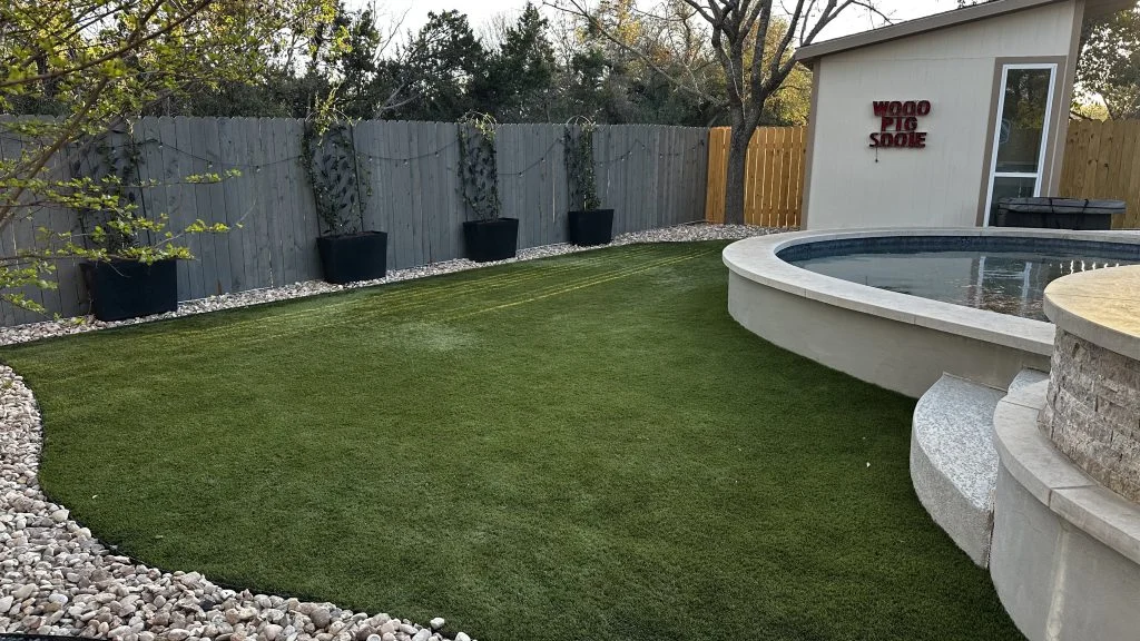 Yard with artificial turf, a swimming pool, and storage shed.