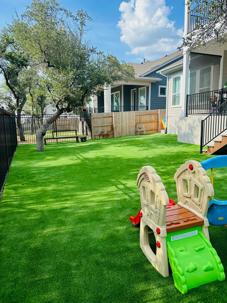 Backyard with children's play set on artificial turf